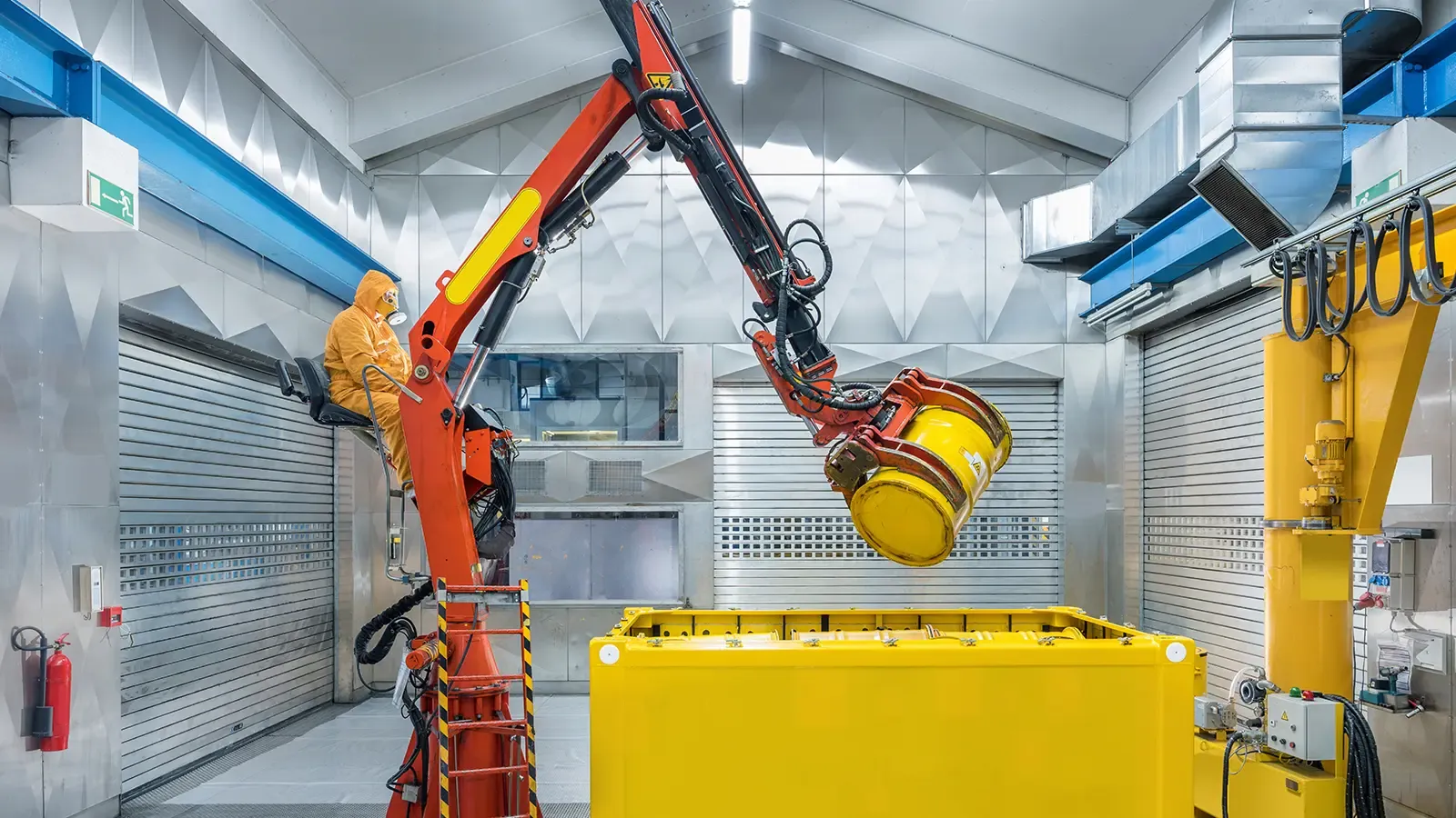 Lab worker moving materials by robotic crane arm