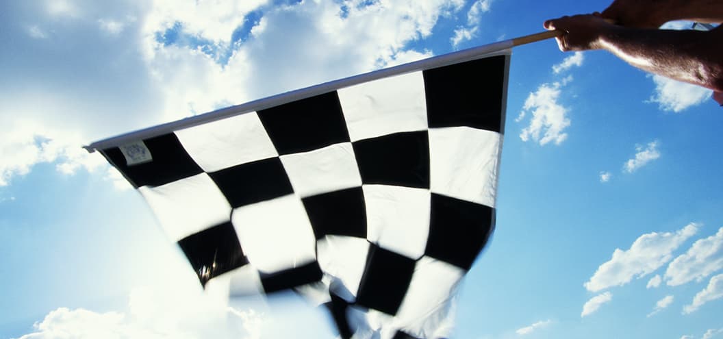 man waving checkered race flag