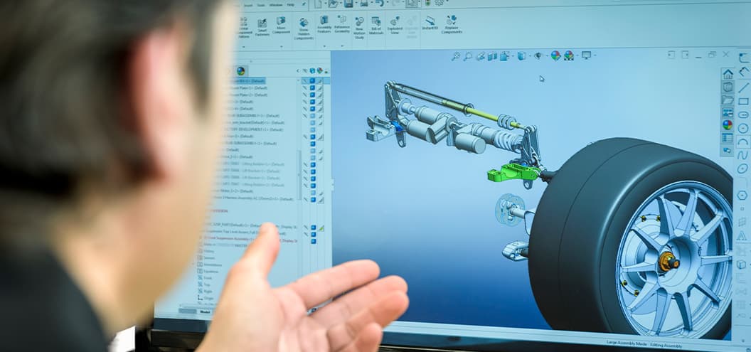 man looking at model of car wheels