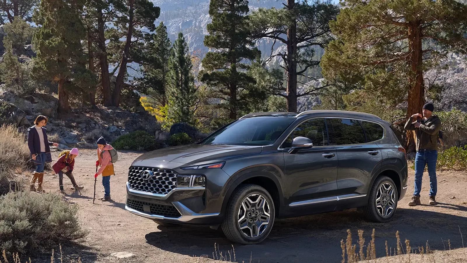 2021 Hyundai Santa Fe Hybrid parked on a mountain with family outside