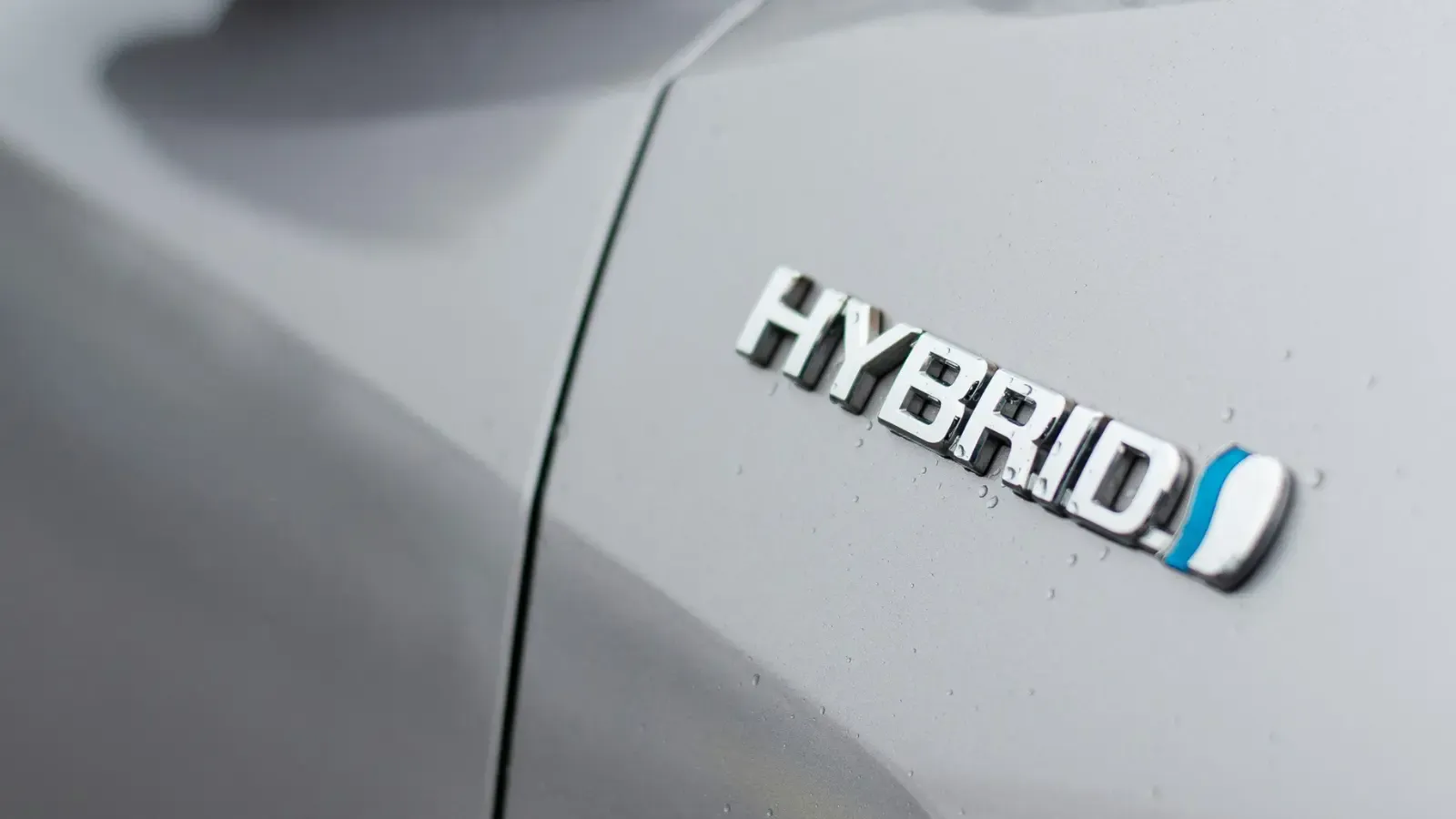 Hybrid vehicle logo on a silver hybrid car